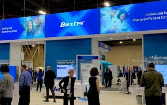 People visiting Baxter's booth at ASHP 2019