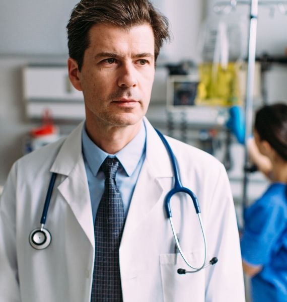 A close up of a male doctor in a hospital room